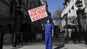 Dr Meenal Viz protesting in Downing Street (Kirsty Wigglesworth_AP)